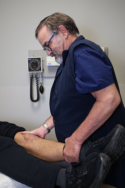 Dr. Devlin working with a patient's knee