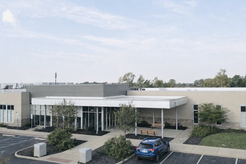 Exterior of Internal Medicine - Pediatrics with a parking lot.
