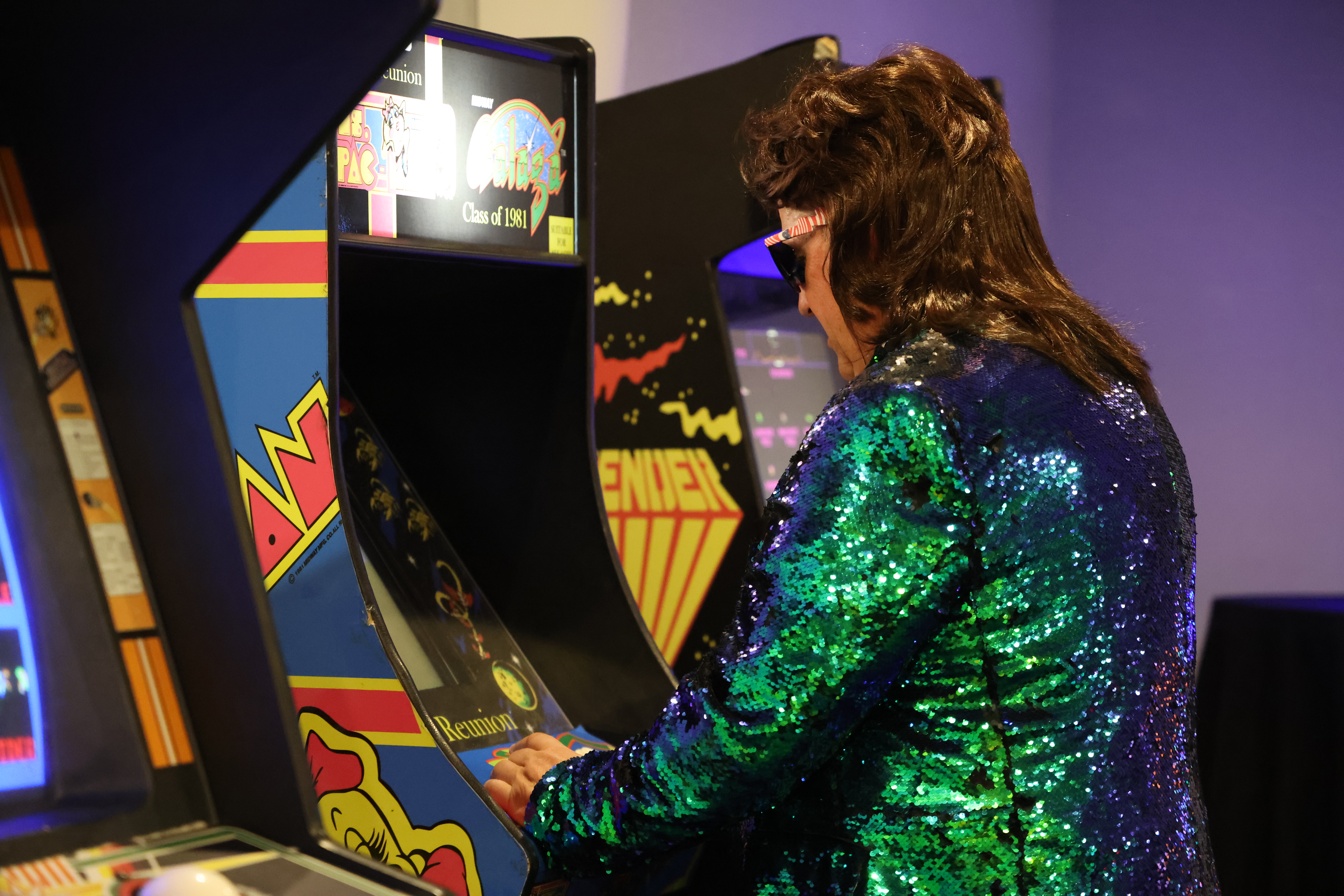 man playing arcade game