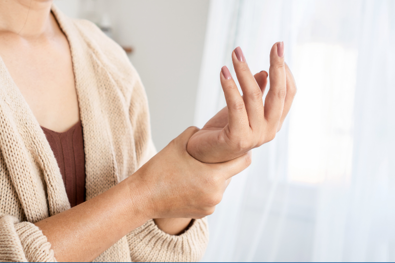 Understanding Rheumatoid Arthritis shows a person holding a sore wrist.
