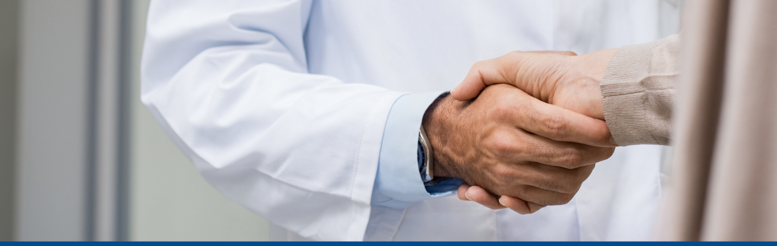Internal Medicine-Pediatrics doctor shaking hands with a patient.