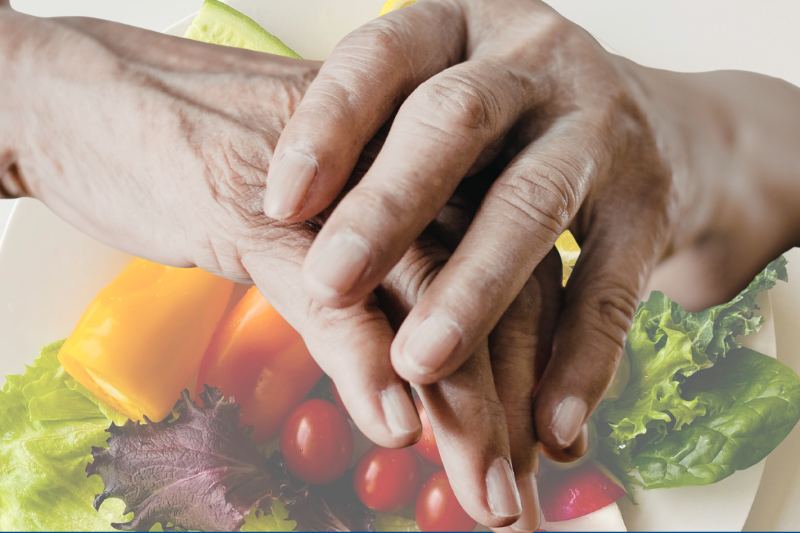 Arthritic Hands over a plate of healthy food