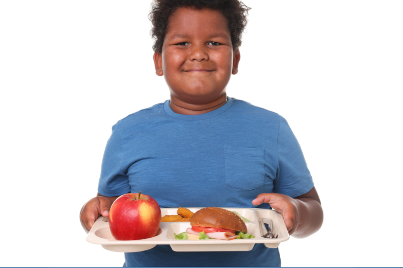A child with a lunch tray of healthy food