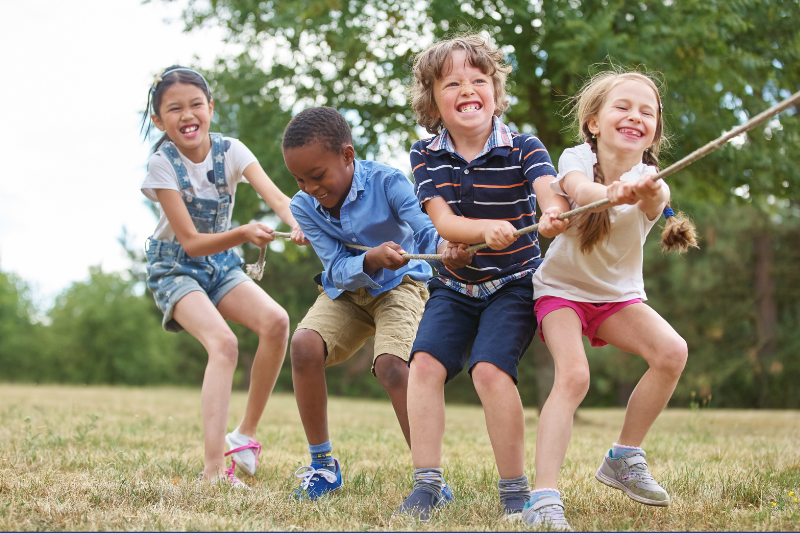 A group of children playing tug of war