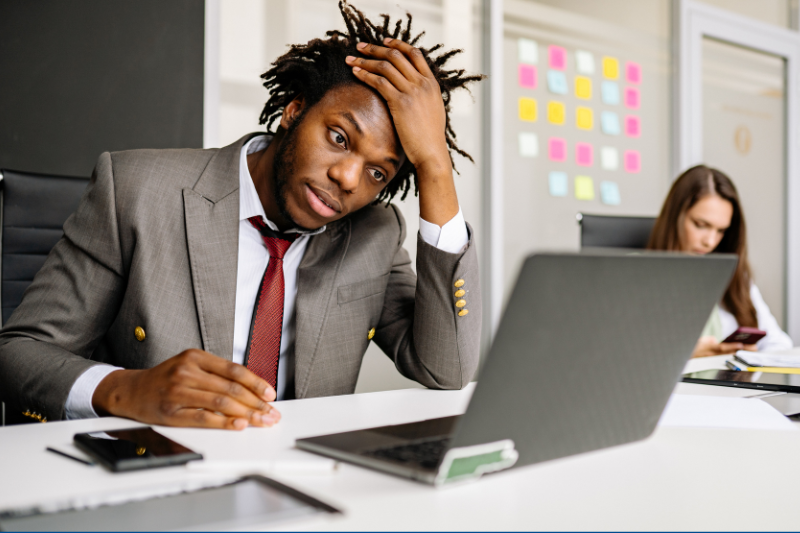 A man in a suit working at a laptop