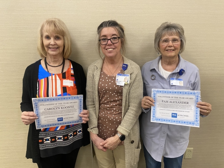 Carolyn Koontz, left and Pamela Alexander, right receiving Volunteer of the Year award from Amy Mitchell, center