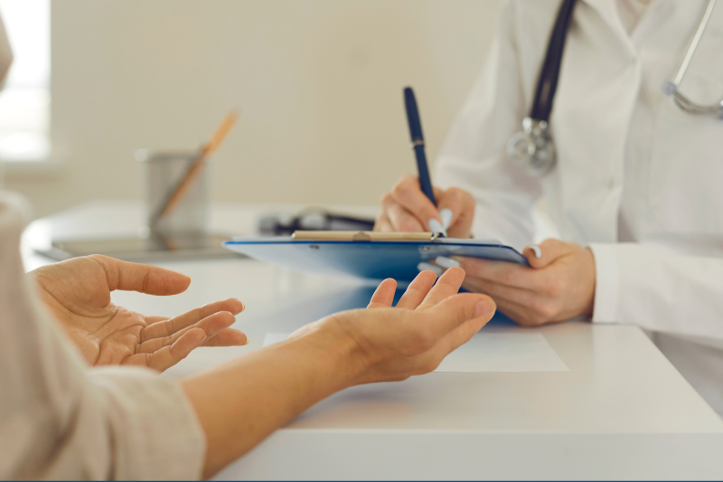 Occupational Health provider talks with a patient during a visit.