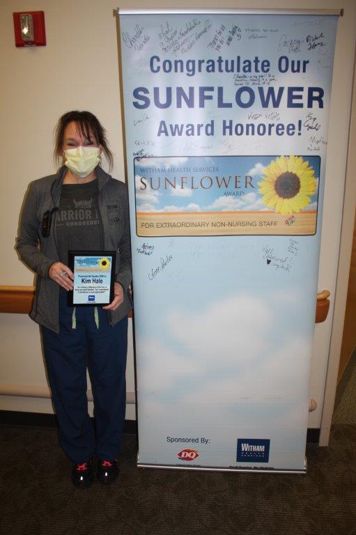 Kim Hale holding Sunflower Award