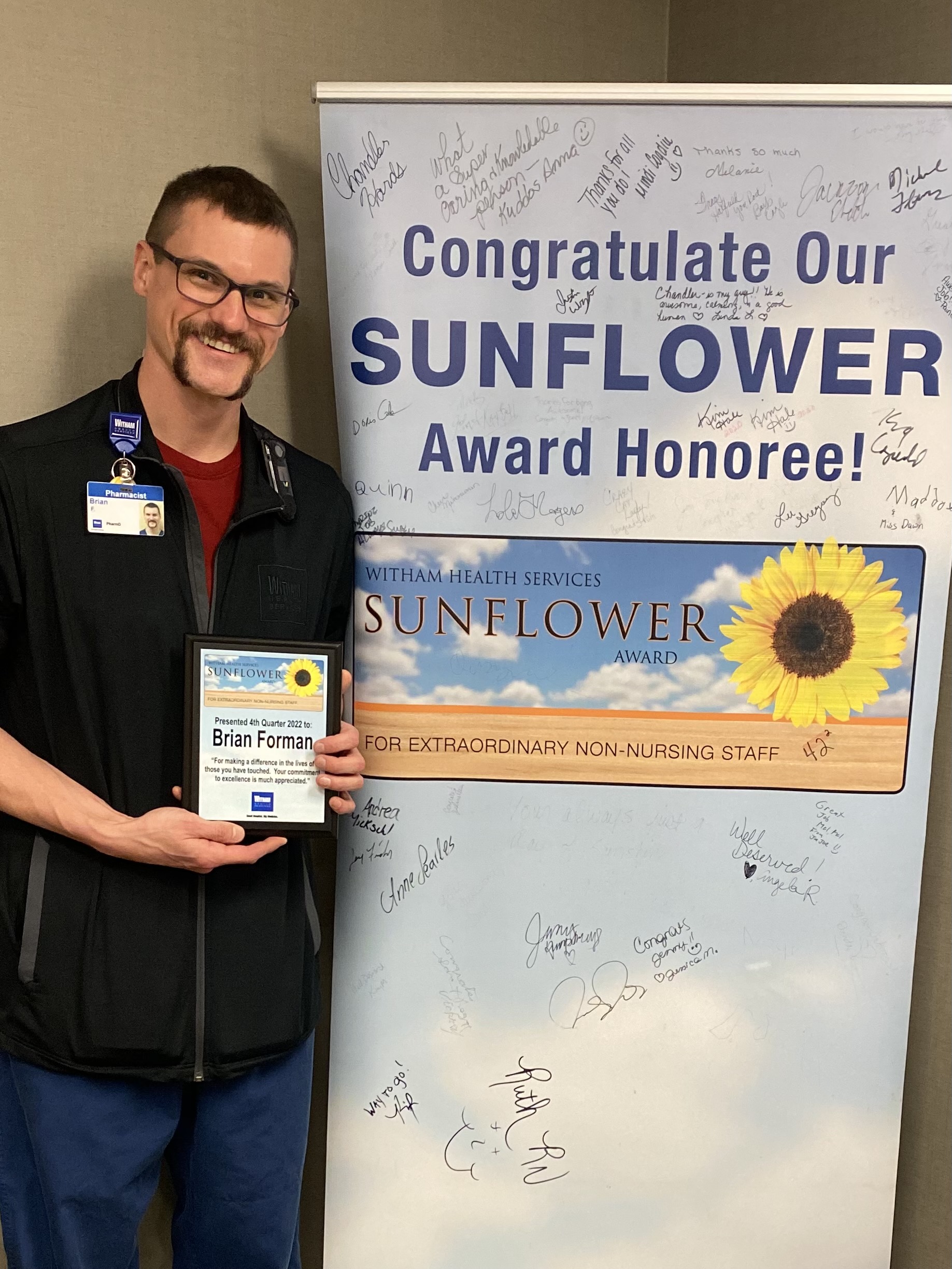 Brian with award plaque and banner