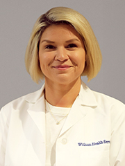 Healthcare provider in a white coat.